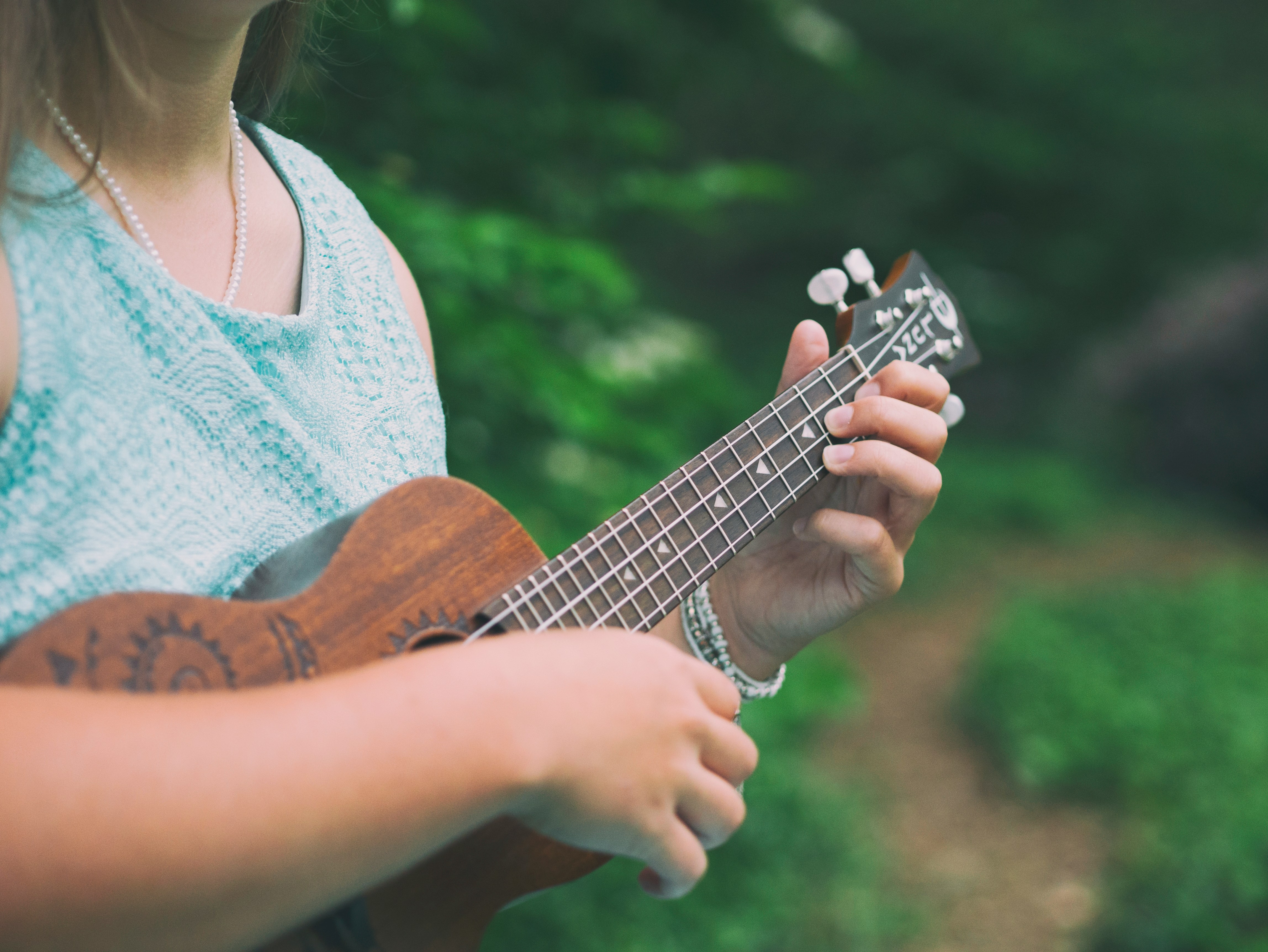 Photo of someone playing a ukulele by Aaron Burden on Unsplash